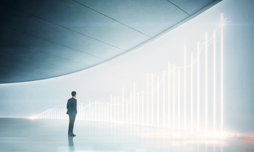 Businessman looking at shining chart on the wall